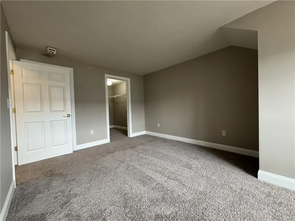 View of typical primary bedroom with walk in closet