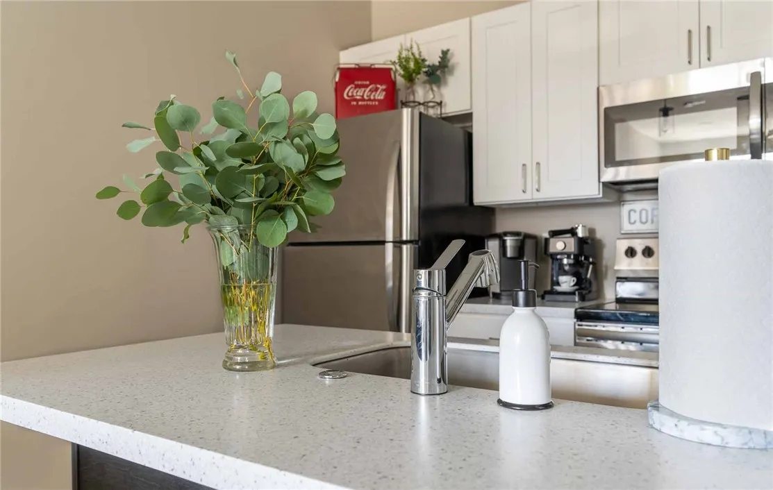 Typical kitchen breakfast bar, stainless steel appliances, dishwasher, etc.