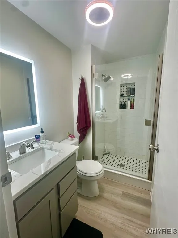 Remodeled master bath has tile shower with built in shelf, fog-less mirror, and Bluetooth ceiling light/fan.