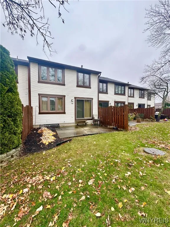 Back patio with fenced sides and sliding door to living area.