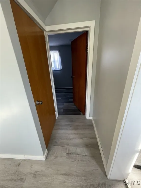 Dining room view of hall access to bathroom laundry area and basement