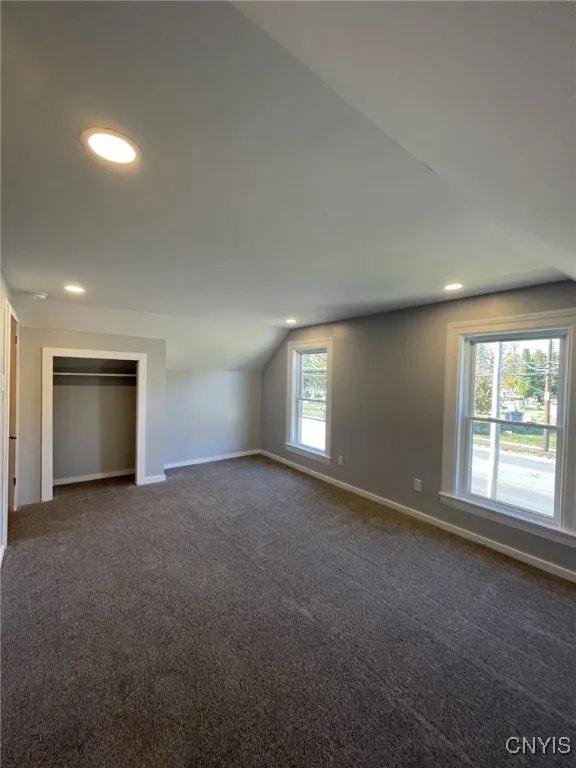 Primary Bedroom; with  windows and closet.