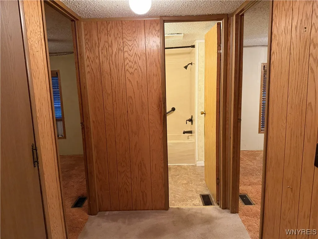 Hallway to bedrooms 2 and 3 as well as full bath