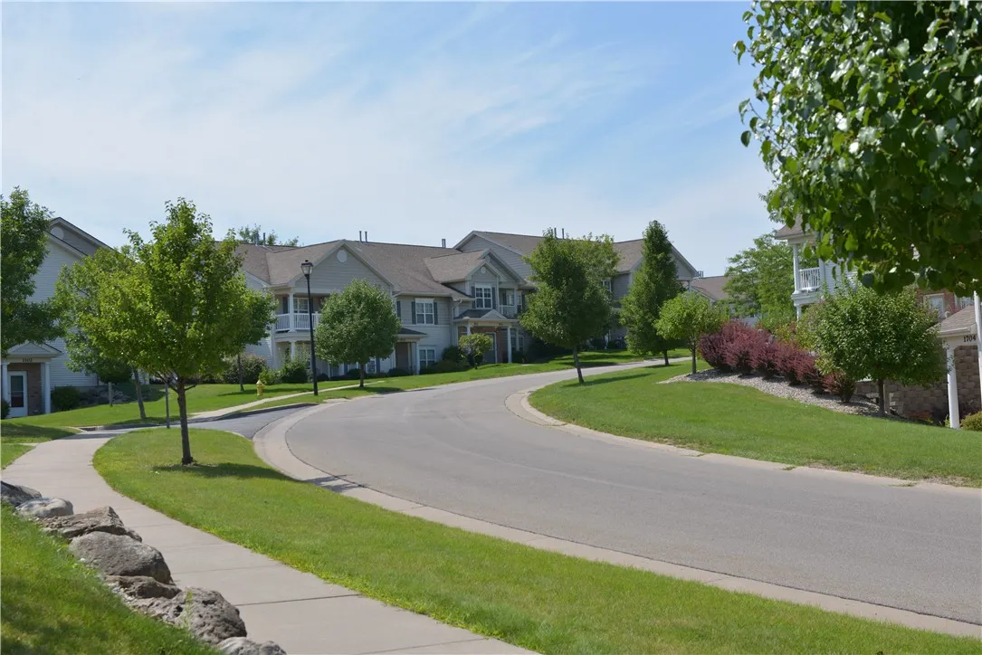 Exterior view of apartment buildings and sidewalk at Parklands of Chili