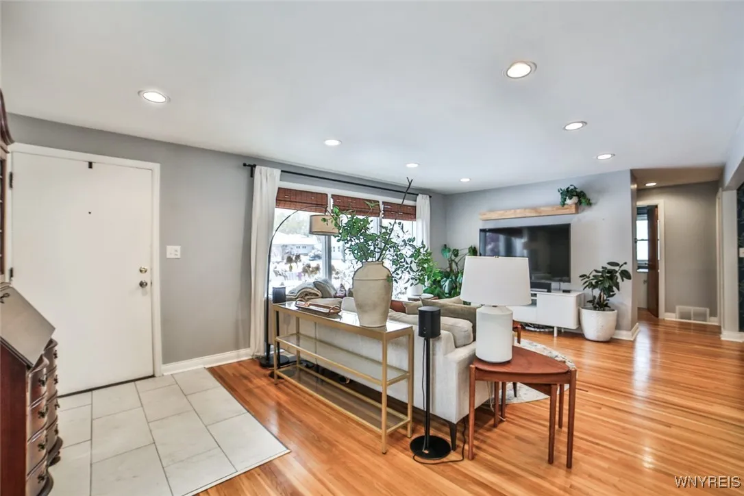 The living space is bright and open with gleaming re-finshed hardwood floors.