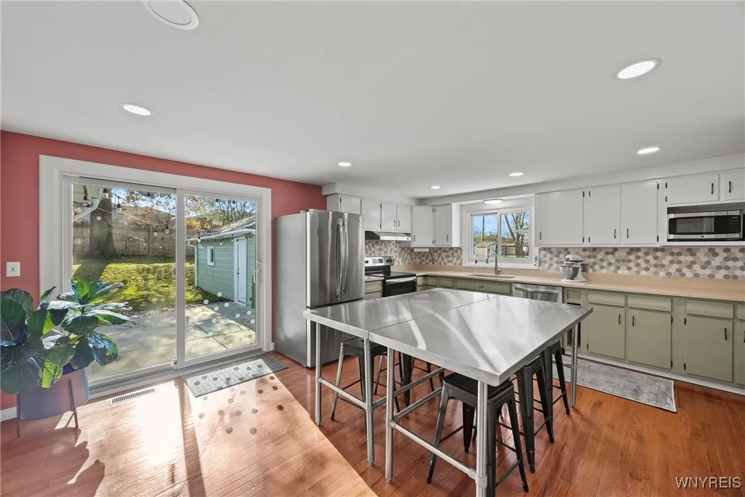 Hardwood floors continue, sliding door to patio