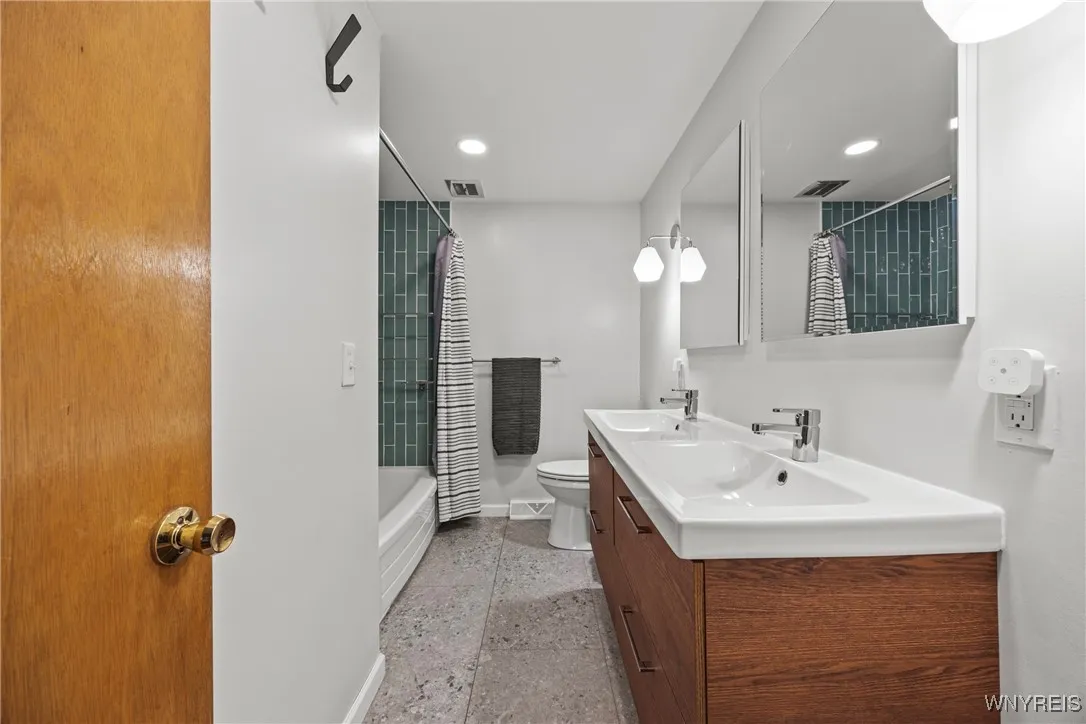 Updated bath with dual sinks, tile flooring