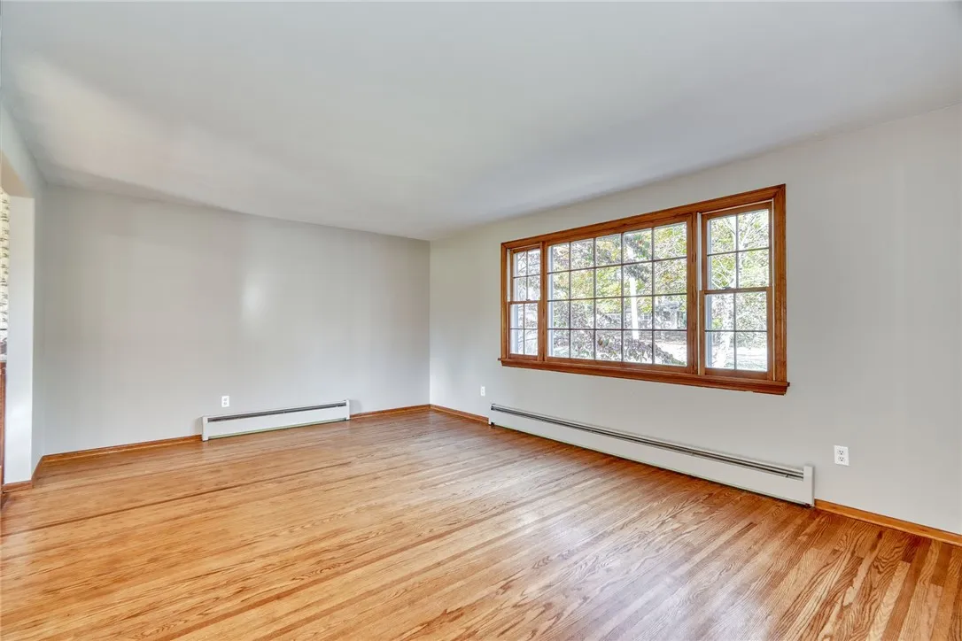 Formal living Room with Large Bay Window and hardwood flooring.