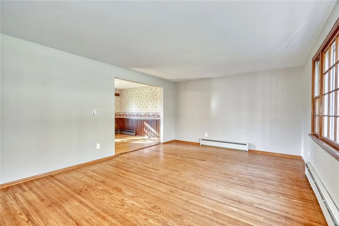 Formal living Room with Large Bay Window and hardwood flooring.