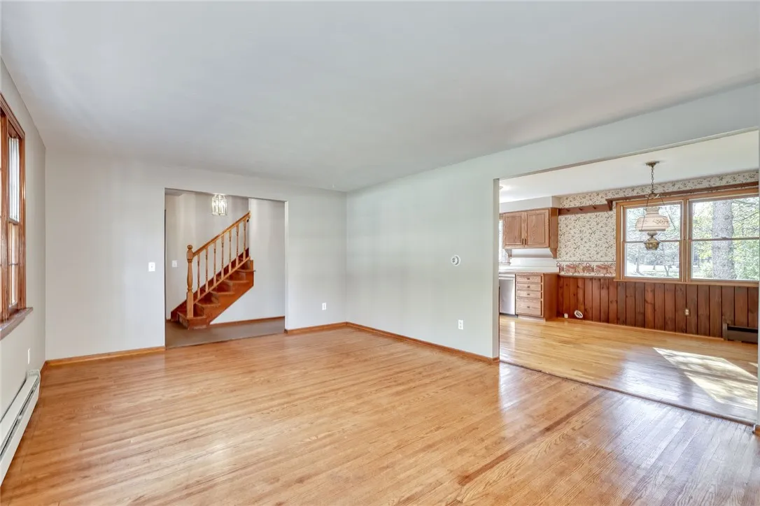 Formal living Room with Large Bay Window and hardwood flooring.