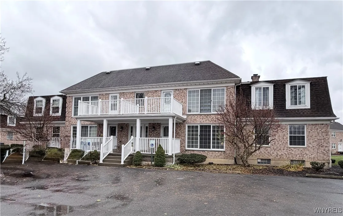 Entry to Lower Level Unit with Covered Porch that is steps to Garage, additional Parking and Pool