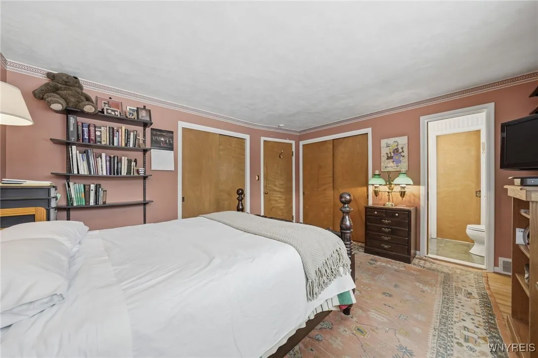 Primary bedroom with double closets & half