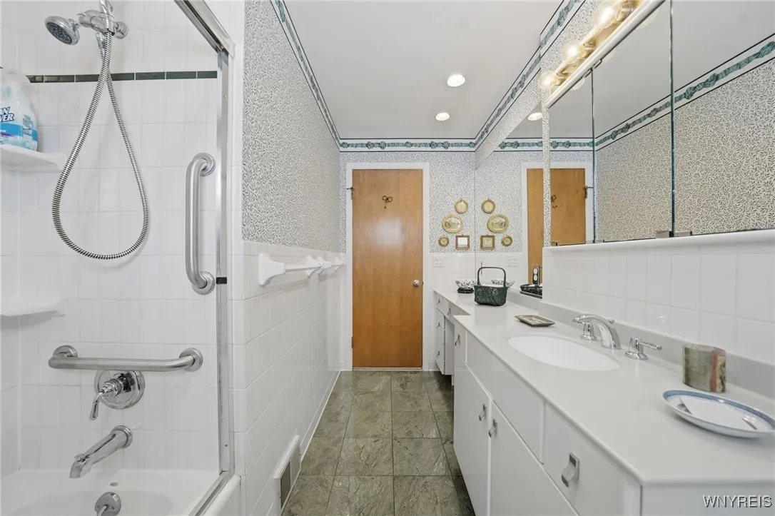 Full bath with ceramic floors & white cabinets