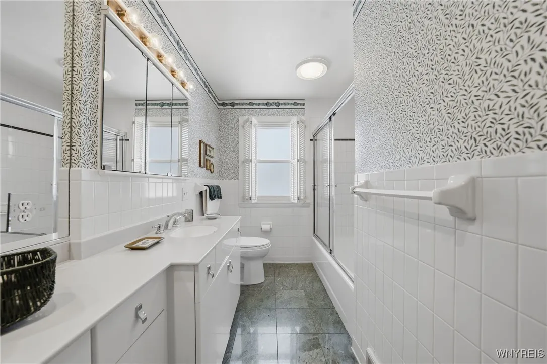 Full bath with ceramic floors & white cabinets