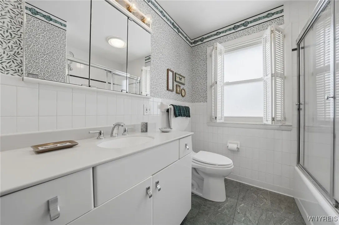 Full bath with ceramic floors & white cabinets