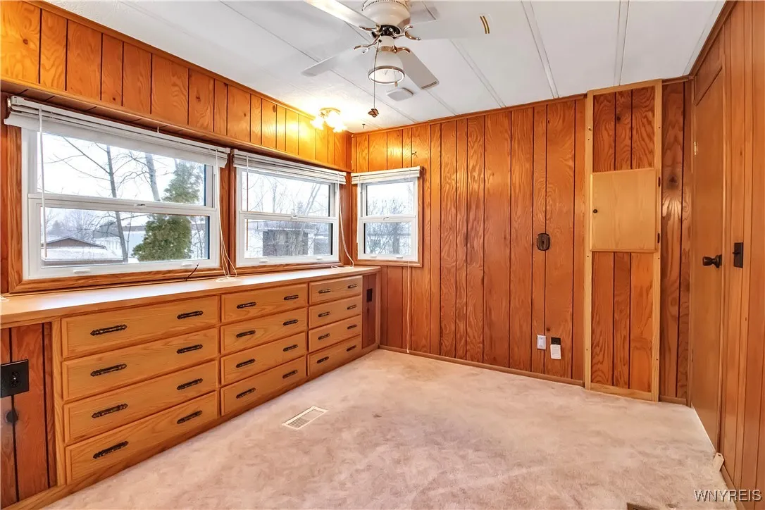 11x10 bedroom has 2 ceiling light fixtures, ceiling fan + door on wall to circuit breaker box