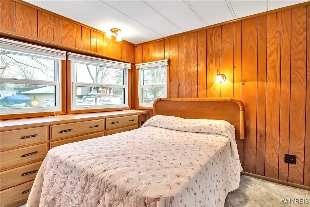 Carpeted Primary front bedroom has built-in storage drawers