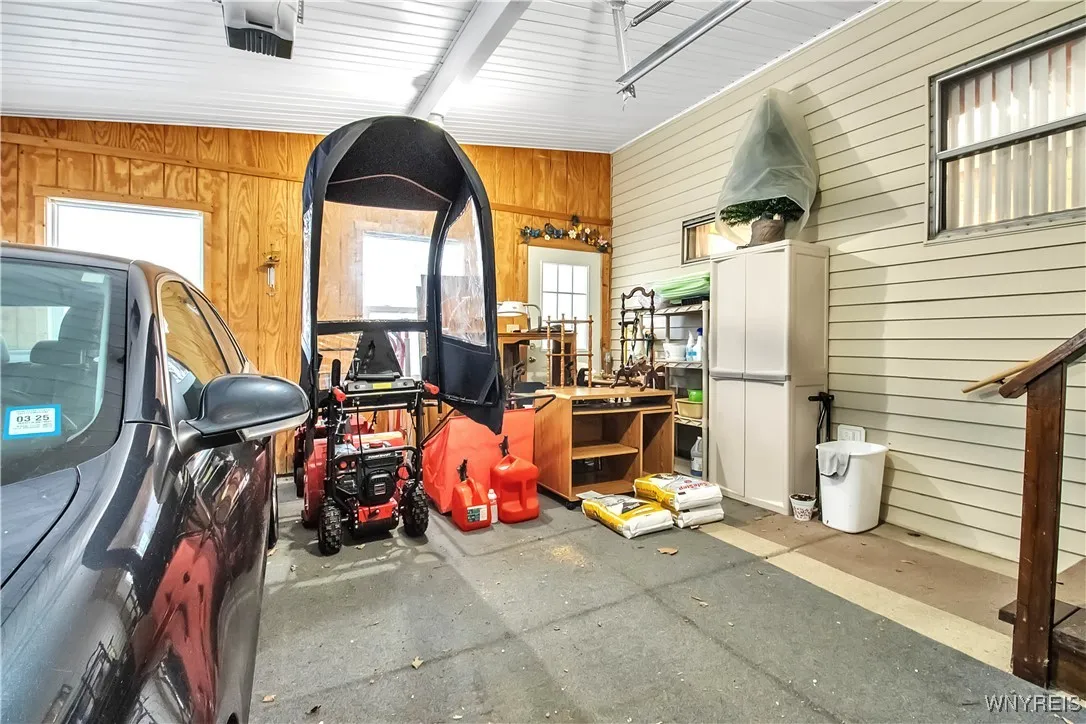 Inside of .5 car attached garage w/automatic door opener + service  door to backyd