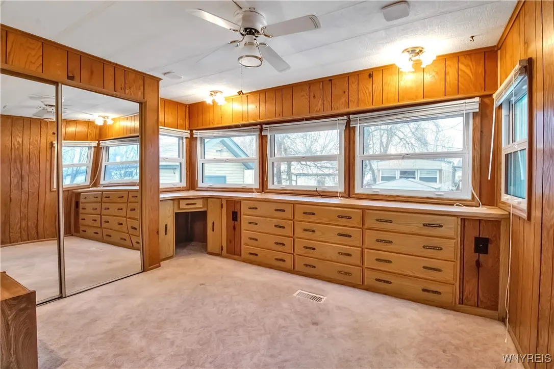 11x10 carpeted back bedroom has built-in drawers + sliding mirrored closet doors