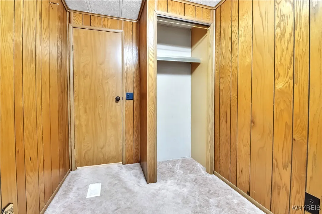 Carpeted 10x6 bedroom has closet with shelf - currently was used as a Den