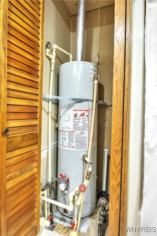Hot water tank inside bathroom behind shuttered bifold doors