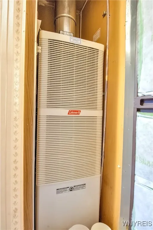 Forced air furnace located in hallway behind insulated shuttered door