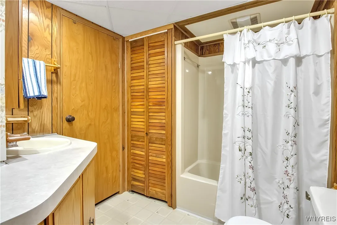 Full Bath has shuttered bifold doors with hot water tank