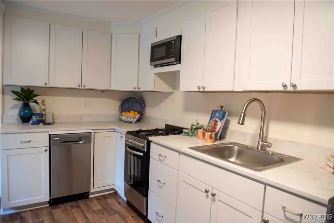 BRAND NEW WHITE SHAKER STYLE CABINETRY - NEW COUNTERS- NEW SINK- NEW FAUCET-NEW APPLIANCES STAY IN KITCHEN