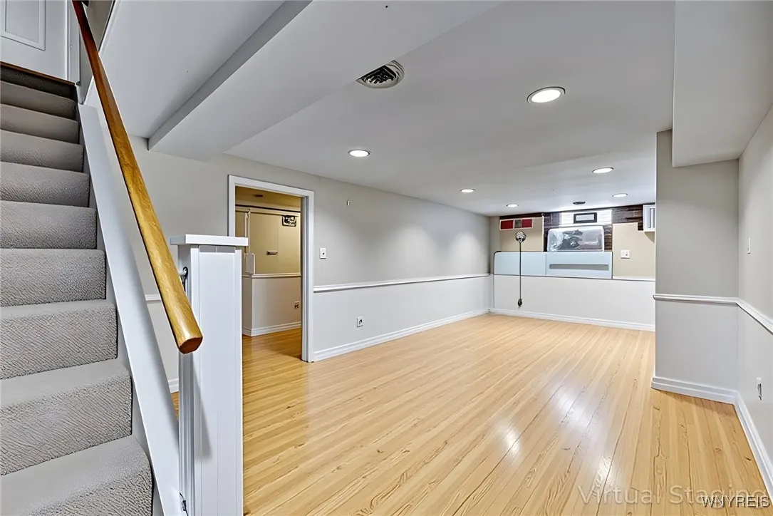 RECREATION ROOM--THIS IS VIRTUALLY STAGED FOR POTENTIAL IDEAS! HAS LIGHT COLORED LAMINATE FLOORING