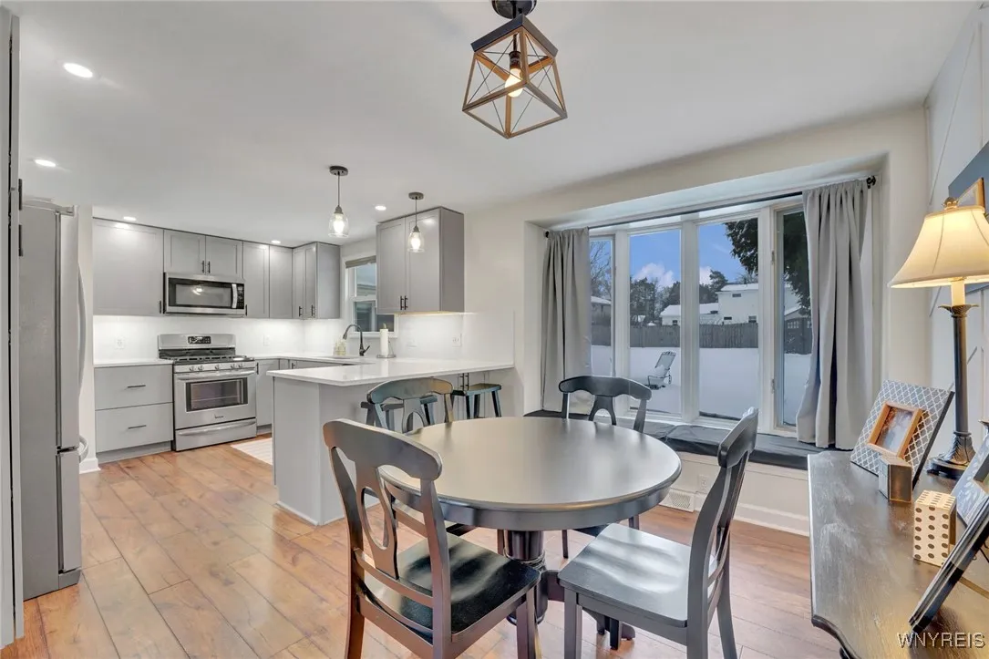 LARGE PICTURE WINDOW WITH BENCH OVERLOOK FULLY FENCED YARD
