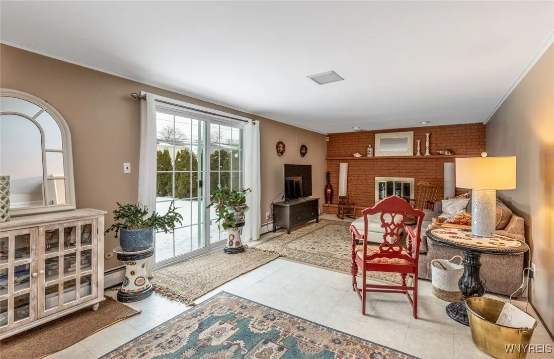 Such a lovely family room - both bright and cozy with a raised hearth gas fireplace and doors that lead to the backyard. This is a huge room that is overlooked from the kitchen. The sliding doors and the front door in 2018.