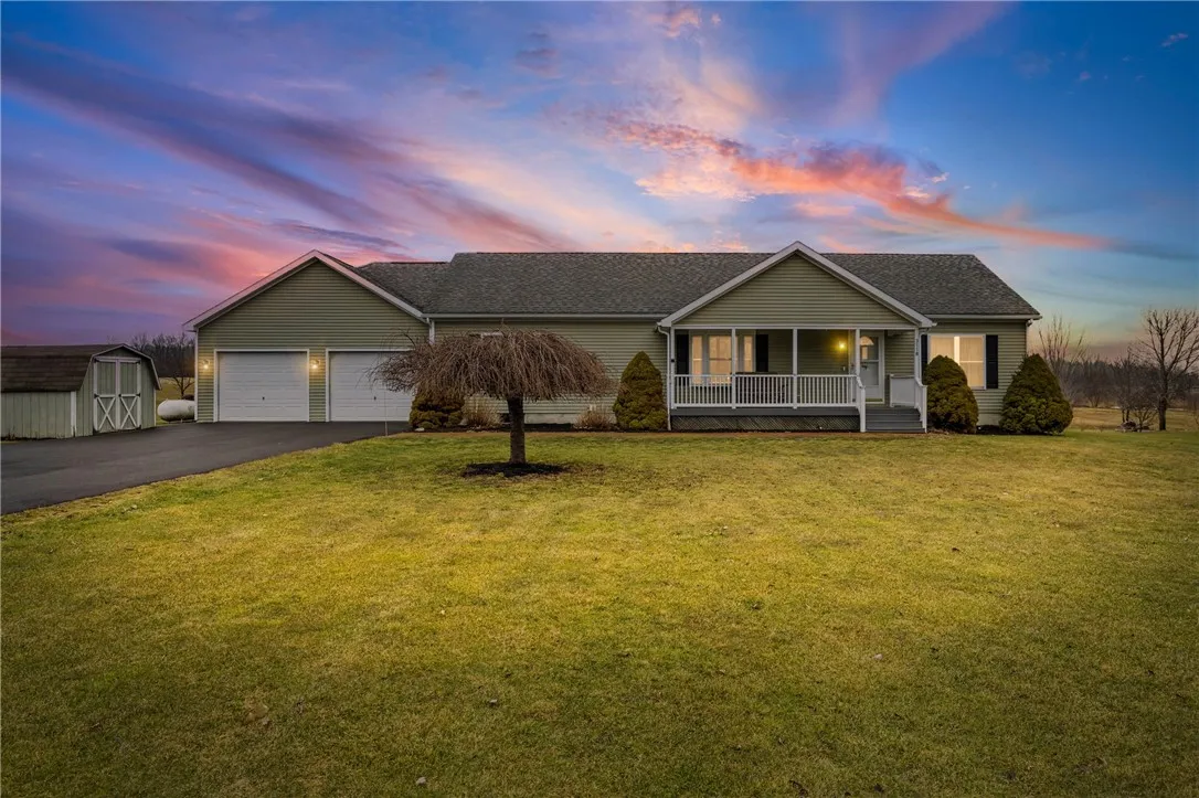 Night view showing the storage shed next to driveway