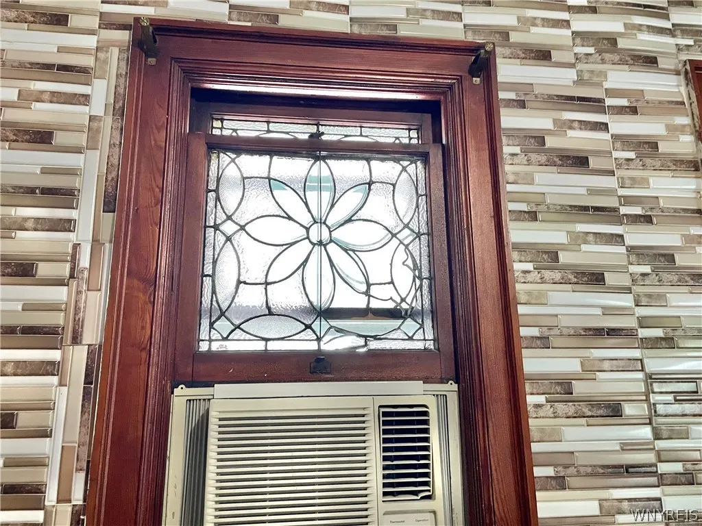 Tile looking wall section is not real tile but imitation tile - plastic stick down. Seems easily removable.