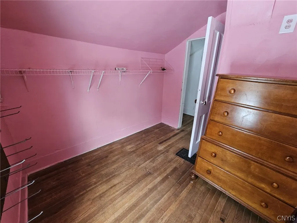 corner view of small bedroom/walk in closet.