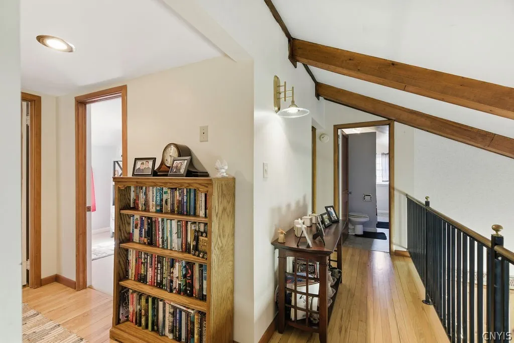 View of the 2nd floor landing, bedroom and full bath on the left and another bedroom and full bath to the back.