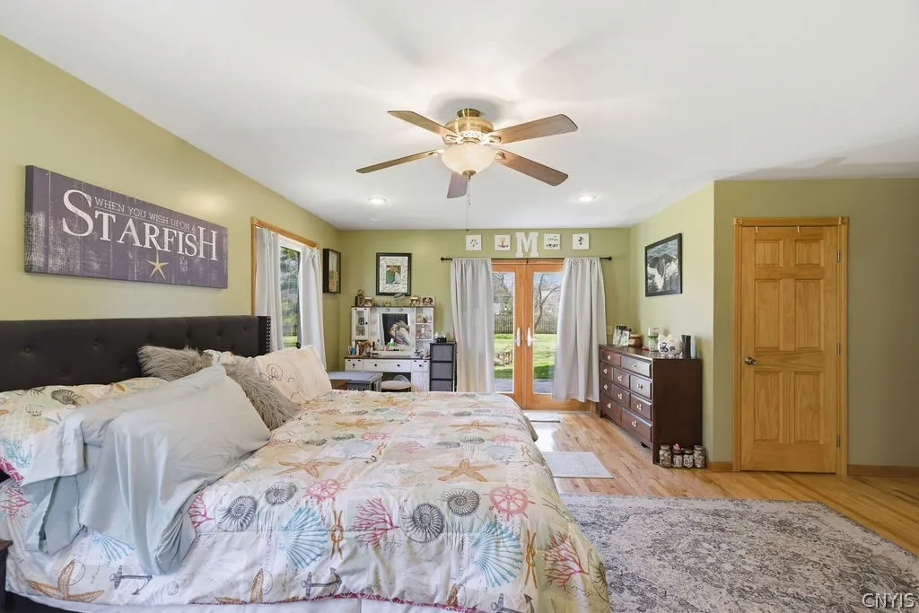 Primary bedroom suite, French doors to the deck at the back, door to walk-in closet on the right.