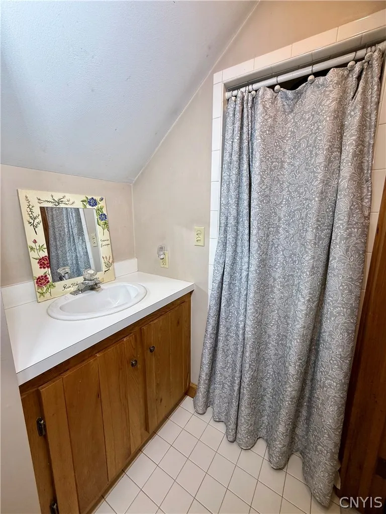 Private in-law quarters above the garage, complete with its own living room, bedroom, and full bath.