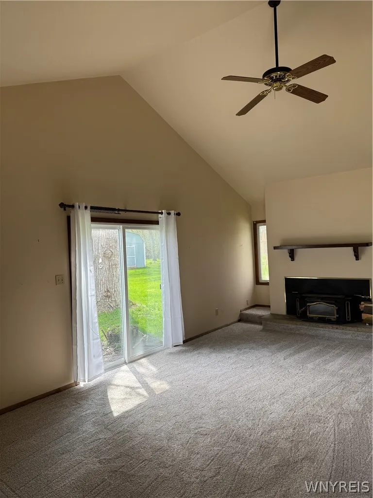 Family Room Addition with cathedral ceiling, fireplace and sliding doors to expansive backyard