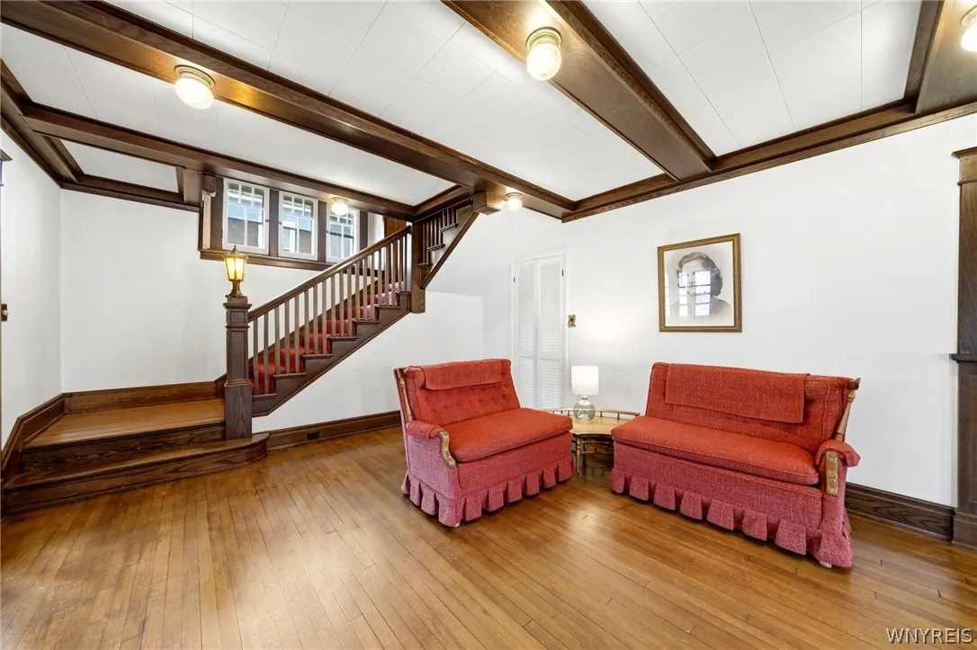 The Living area leads to a beautifully crafted, classic turned wood staircase, rich in historic charm.