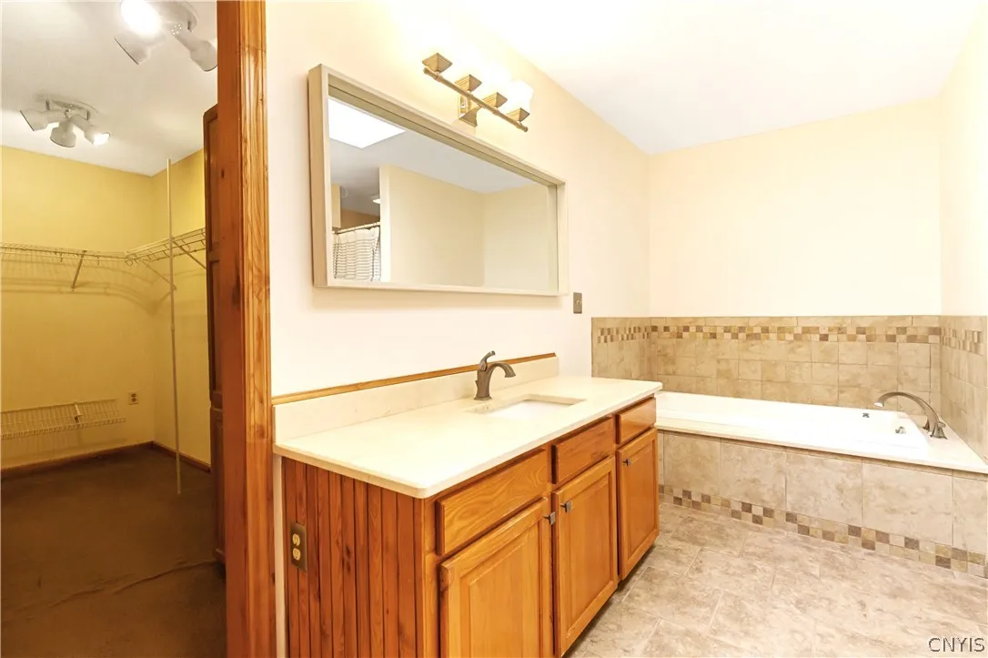 it features a walk in closet, jetted tub