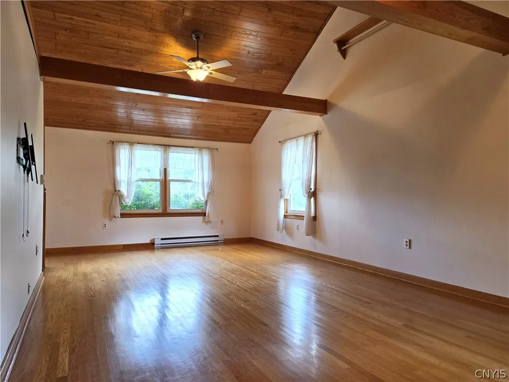 The living room has soaring cathedral ceilings