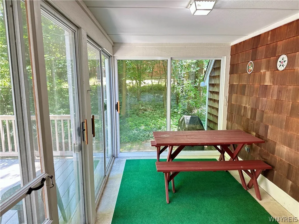Enclosed/screened porch off the back hall