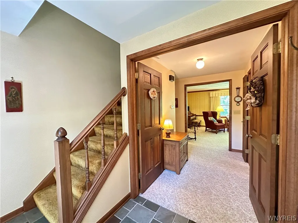 Entryway from front door- (the railing detaches to make moving large furniture upstairs much easier!) double doors lead into the front hall.