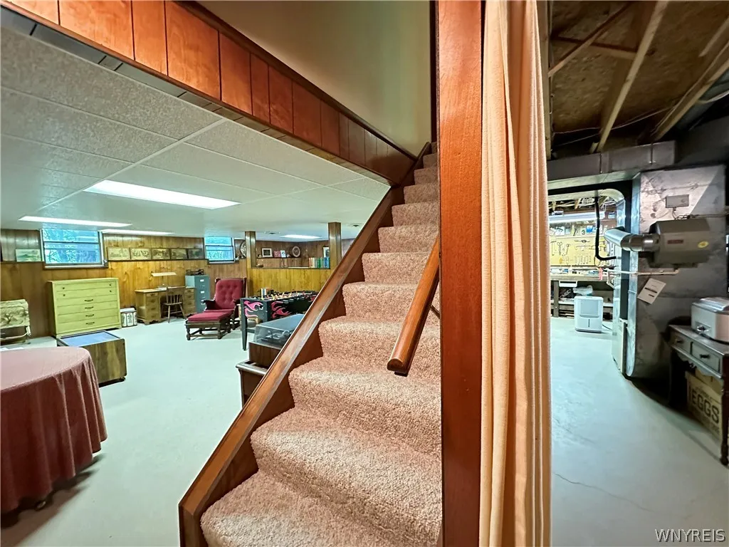 The basement has 2 sides-one finished for additional living space & one for a workshop/storage.