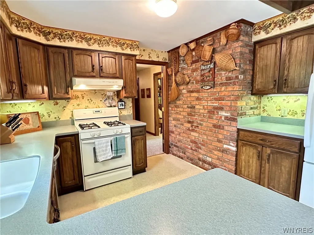 Great layout in this homey kitchen, w/ brick wall & corian counters.
