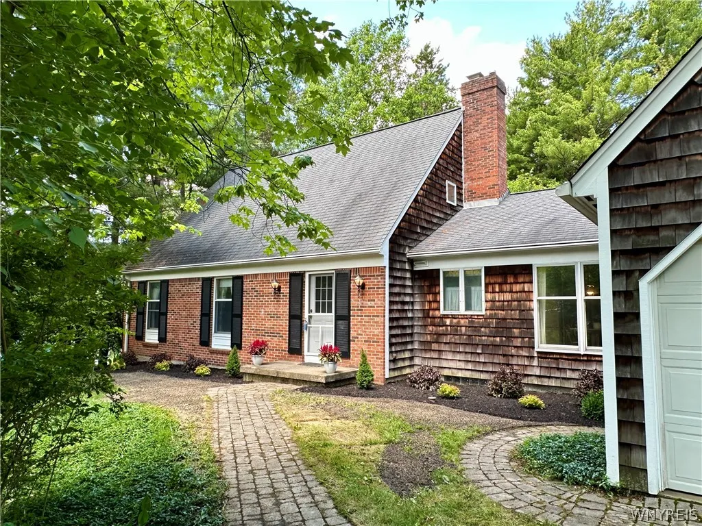Sweet brick & shingle shake cape w/ mature trees.