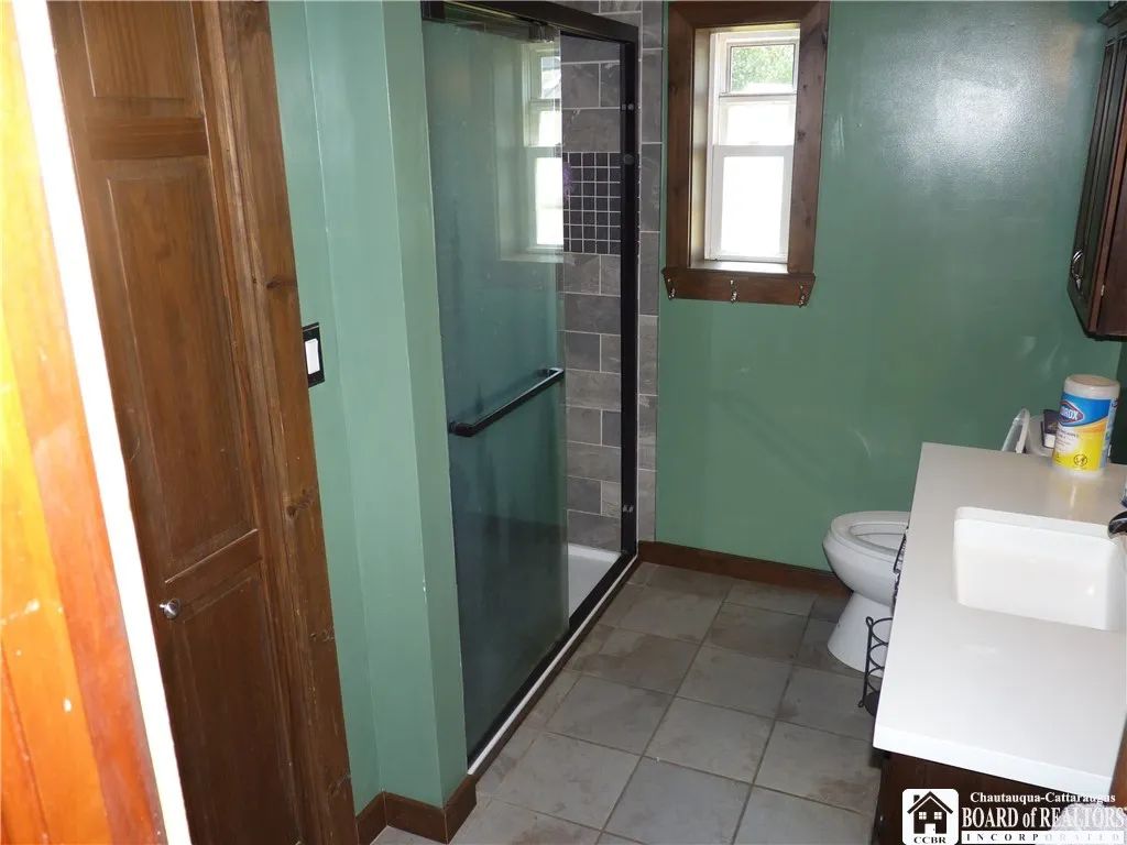 Full bath #1 with tile flooring a vanity