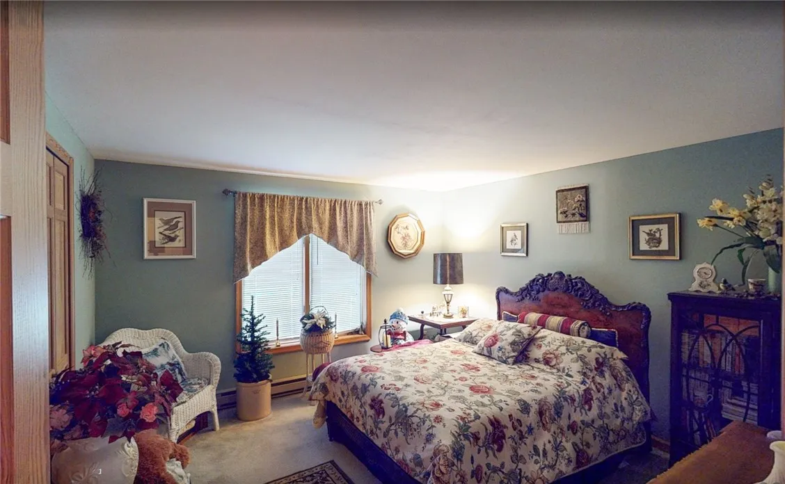 Large bedroom with wall to wall carpet.