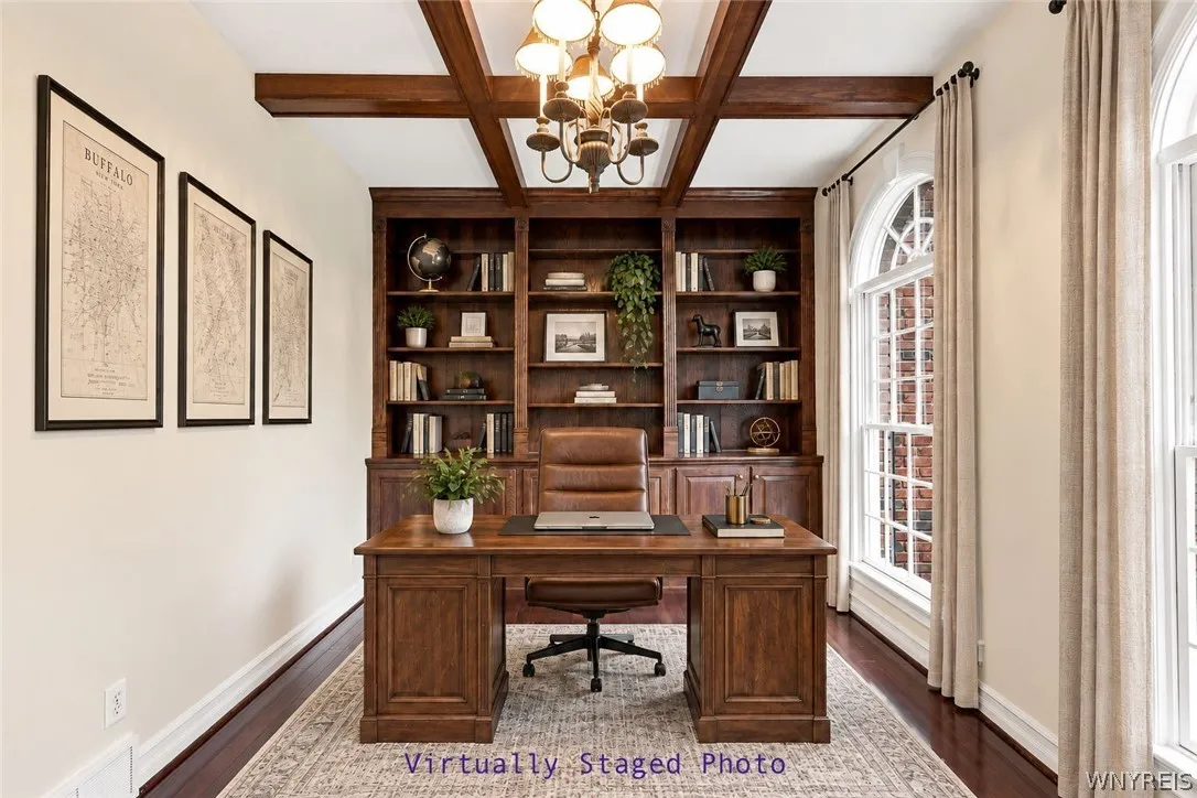 Glistening Rosewood floors flow from the foyer into a sophisticated den/office behind elegant double French doors, complete with an old-world coffered ceiling and custom built-in bookcases.