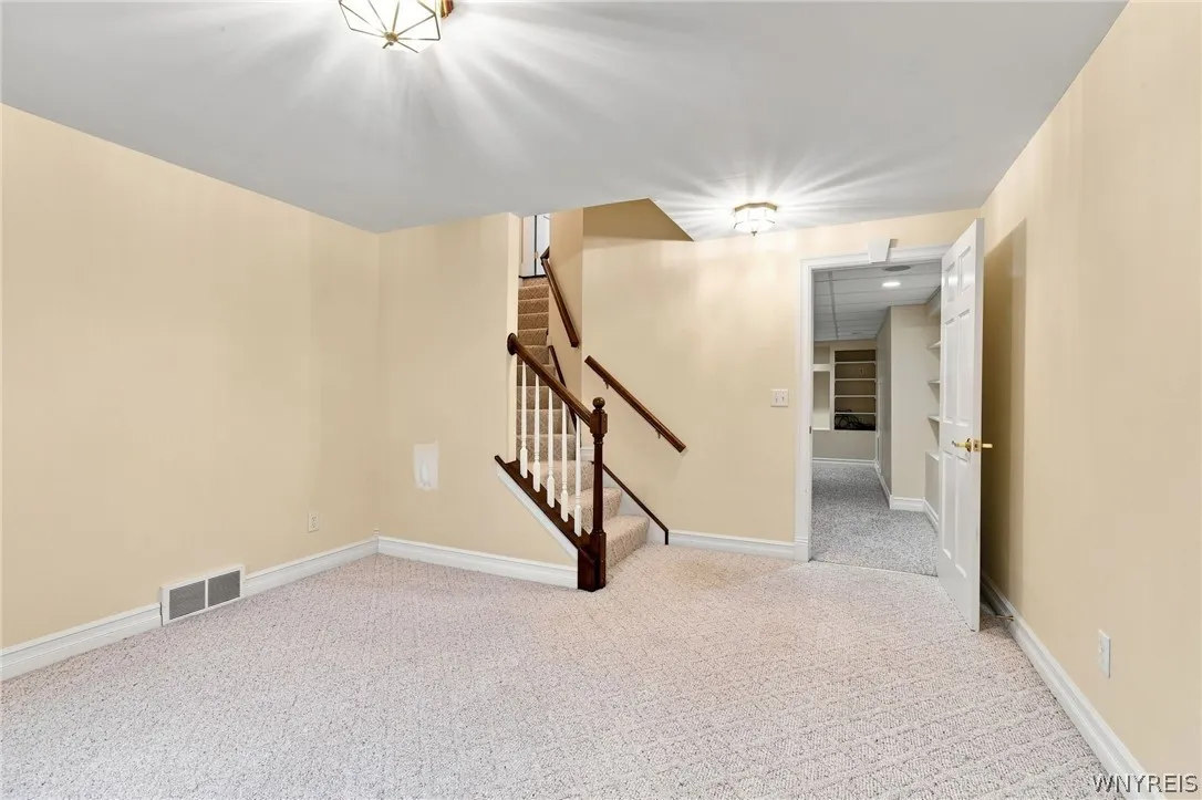 Basement/lower level  recreation space is fully carpeted and has egress window